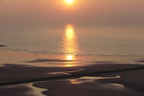 A beach scene with the sun reflecting on the water. - Holiday apartment with 1 bedroom (Middelkerke)