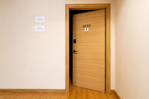 A wooden door with a label 'A1 A2' and a small sign above it.