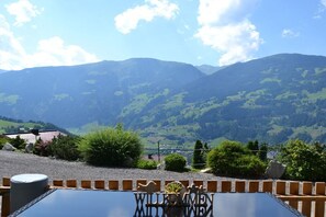 A table with a 'WILKOMEN' sign, surrounded by greenery and mountains in the background. - Holiday apartment with 3 bedrooms (Zell am Ziller)