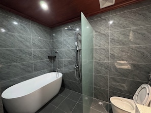 A modern bathroom with a freestanding bathtub, a shower, and a toilet. - Luang Prabang Indochine Heritage Hotel (Luang Prabang)