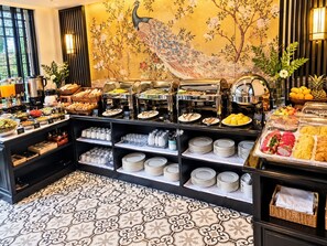 A buffet area with various food options, including fruits, vegetables, and prepared dishes. - Luang Prabang Indochine Heritage Hotel (Luang Prabang)