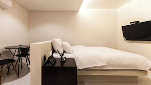 A compact hotel room with a bed, a small table, and a chair. - Hotel Yaja Daegu Seomun Market (Daegu)