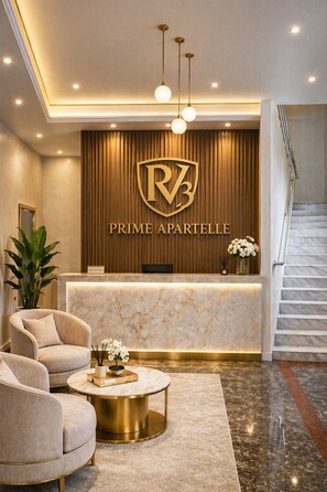 A reception area with a marble counter, a reception desk, a staircase, and two plush armchairs. - RV3 Transient House (Angeles)