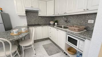 Apartment, Balcony, Pool View | Private kitchen | Electric kettle