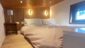 A bedroom with a bed, bedside tables, and a television. - Cabin - Sleeps 6 - Parking (Meath)