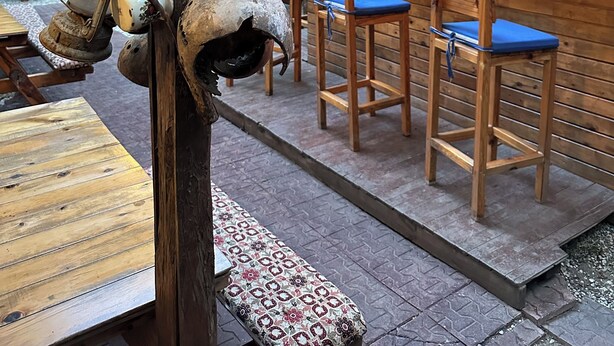 A rustic outdoor bar with wooden furniture and a sign that reads 'NATURAL BAR.' - Natural Pansiyon (KUMLUCA)