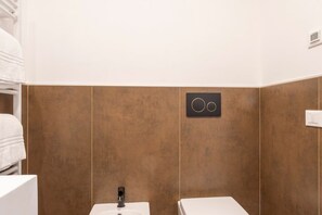 A bathroom with two sinks, a towel rack, and a wall-mounted control panel. - Marghera Smart Stay 2 | A Comfortable Room in Venice (Marghera)