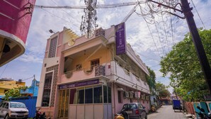 A two-story building with a sign for 'Vel-Ohm Stay' indicating a hotel or guesthouse. - Vel Ohm Homestay (Puducherry)
