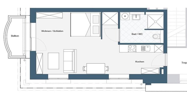 A floor plan with a balcony, living/dining area, kitchen, bathroom, and a separate toilet area. - Villa by the Swan Pond (Fehmarn)