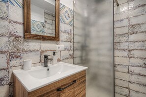 A bathroom with a white sink, wooden cabinet, and a mirror. - Cortijo Eucalipto 1 with Sea Views, Private Pool, and Air Conditioning (Nerja)