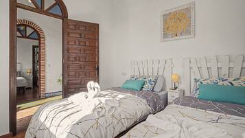 A bedroom with two beds, a wooden door, a mirror, and a wall-mounted artwork.