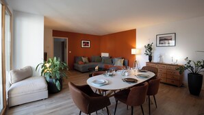 A modern living room with a dining area, a sofa set, and a coffee table.