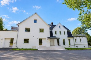 A two-story house with a symmetrical facade, a central entrance with steps, and a small porch. - **Private Mountain Retreat with Exceptional Panoramic Views for 4 persons** (Winterberg)