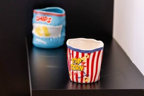 Two containers, one labeled 'CHIPS' and the other 'POP CORN,' placed on a black surface. - Fun - Sized Design studio next to Acropolis (Athens)