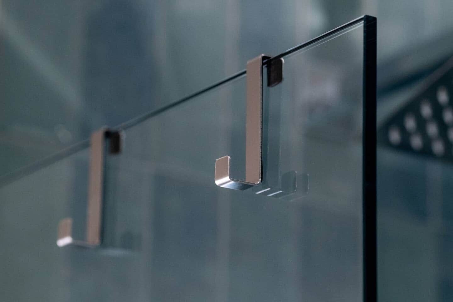 A modern, minimalist interior with a focus on clean lines and glass surfaces.