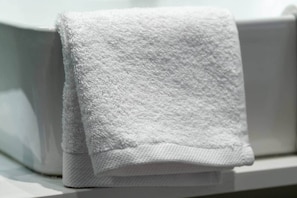 A white towel hanging on a white towel rack. - Pop Urban Escape near the center (Athens)