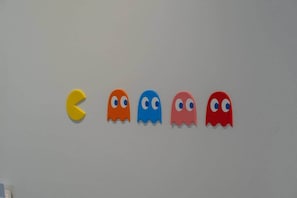 A wall with five ghost-shaped decorations in yellow, orange, blue, pink, and red. - Playful Design close to Athens Highlights (Athens)