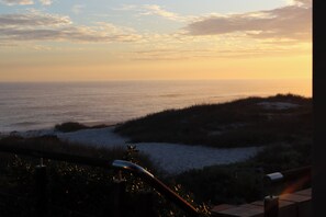 A coastal landscape with a view of the sea and a sandy beach.