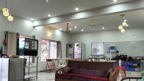 Uma sala de estar moderna com sofá, mesa de jantar e área de cozinha.