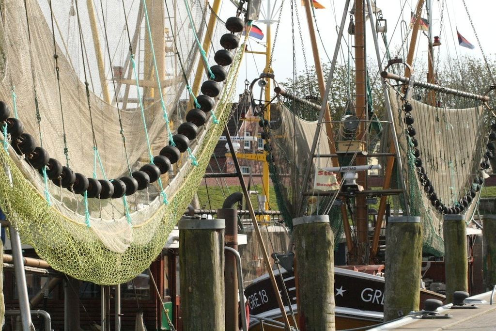 A nautical-themed area with ropes and nets, wooden posts, and a boat with 'GRE 18' visible.