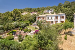 A hillside property with multiple buildings, lush greenery, and a well-maintained garden. - Can Porquer, Luxury villa with a pool near the golf course (IB Pollensa)