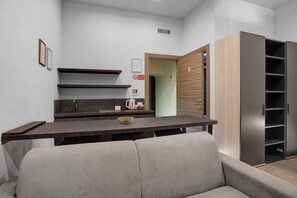 A modern bathroom with a vanity, a sink, a mirror, and a shower area. - Deluxe Room with Balcony, Wi-Fi & Air Conditioning (Napoli)