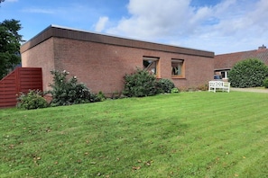 A two-story brick building with a flat roof, a small window, and a sign indicating a price of 299. - Holiday home in Aurich with swimming pool (Aurich)