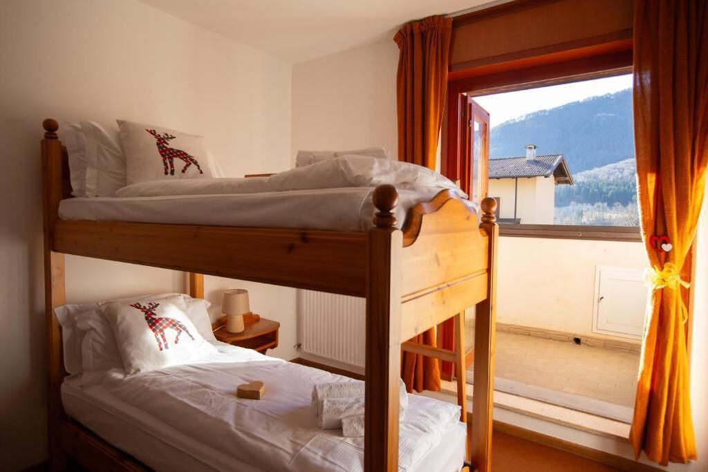 A bunk bed room with a view of a mountain.