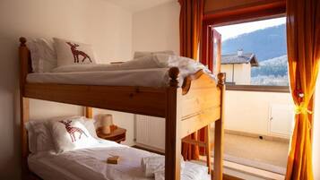A bunk bed room with a view of a mountain.
