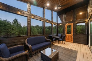 A wooden interior with a sofa, chairs, and a table. - Escape to Nature's Wonderland: The rolling  foothills of Appalachia (Logan)