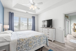 A bedroom with a bed, a dresser, a television, and a ceiling fan. - 10% off 3-7 nights thru Dec. 2BR 2BA condo. Lake view, gated comm. Short walk to beach. (North Myrtle Beach)