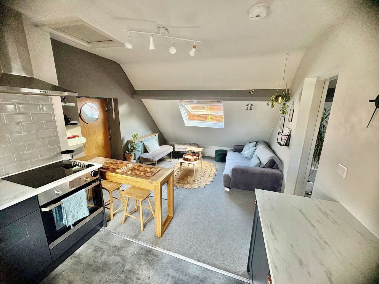 A compact living space with a kitchen, dining area, and seating area.