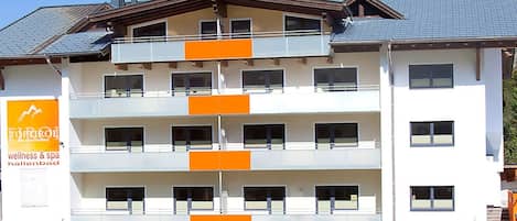 A multi-story hotel with balconies, a spa, and wellness services.