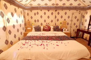 A room with a bed, pillows, a nightstand, and a chair. - The Sandy Resort  (Sam)