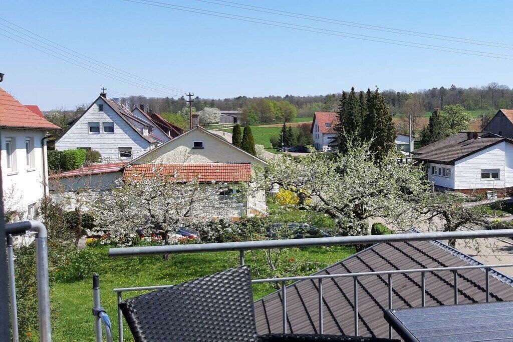 A residential area with houses, a garden, and a metal railing.