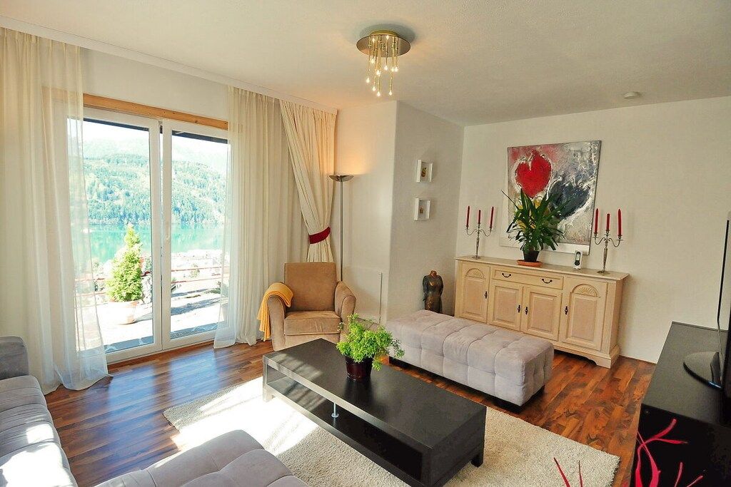 A living room with a sofa, a coffee table, a cabinet, and a painting.