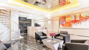 A modern lobby with a marble floor, a staircase, and a coffee machine. - Marine Point Pansiyon (Antalya)