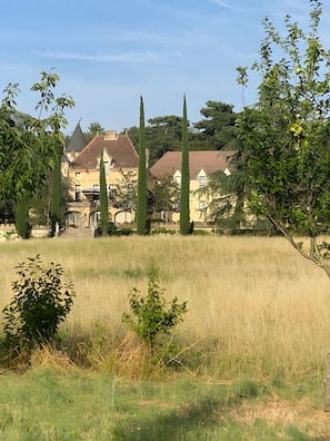 Un campo cubierto de hierba con un edificio al fondo.