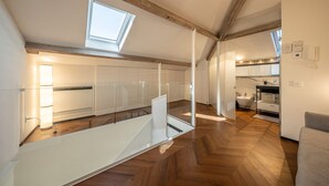 A modern interior with a mezzanine level, wooden flooring, and a skylight. - LUX APARTMENT - Comfort and Style in the Heart of Santa Margherita (Santa Margherita Ligure)
