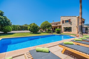 A pool area with lounge chairs and a stone building with a tiled roof. - Caseta DE Lloseta Ref Vp22 1 (Lloseta)