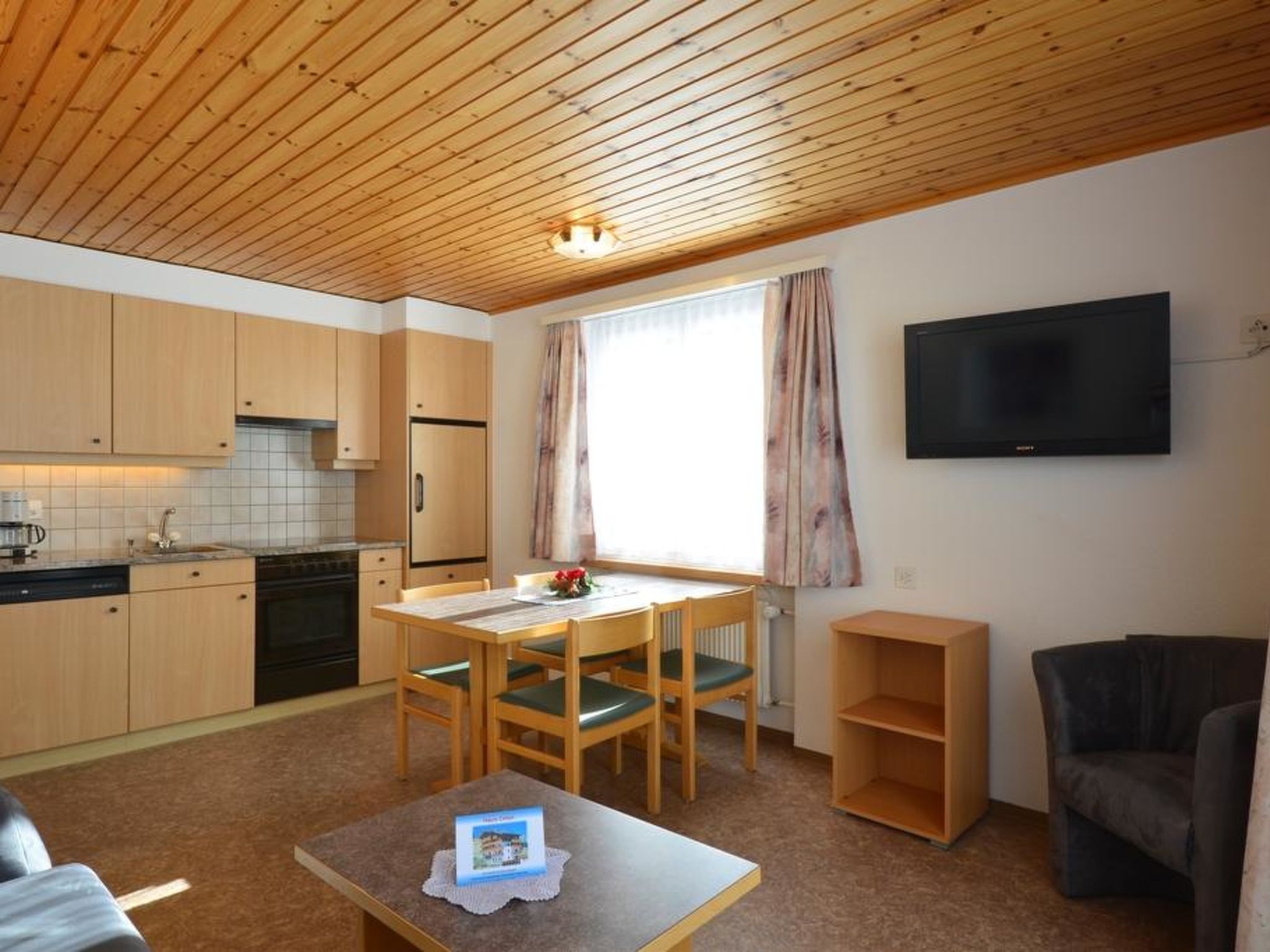 A compact living space with a kitchen, dining area, and a seating area.