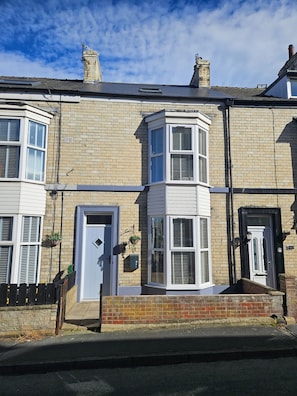 A two-story residential building with a bay window, a front door, and a small porch area. - Salt Sage - Whitby (Whitby)