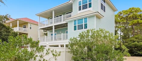 A two-story house with a balcony and a covered porch.