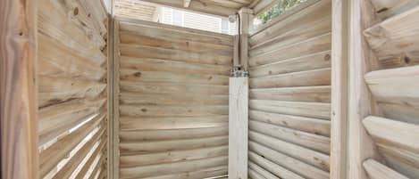 A wooden interior with horizontal slats, a visible door frame, and a small window.