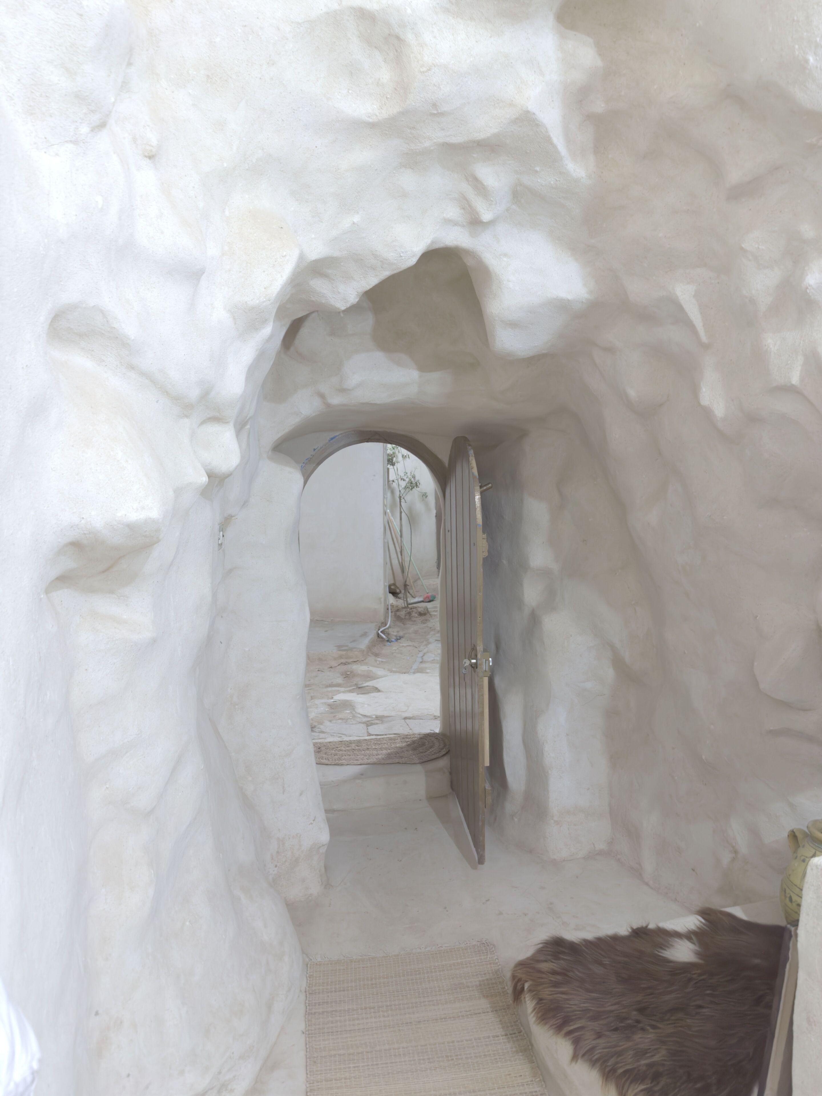 An igloo-like structure with a door leading to an interior space.