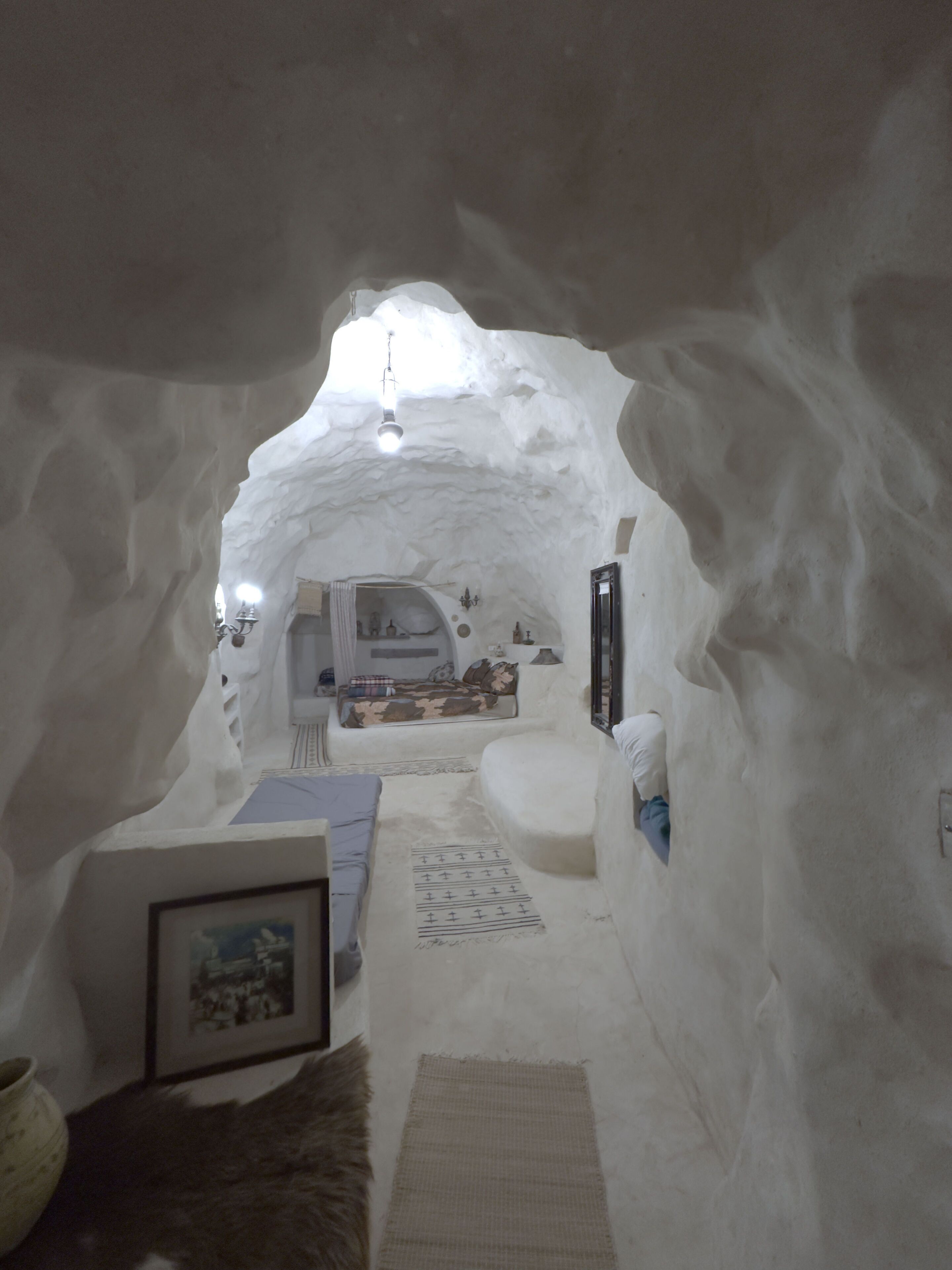 Un intérieur chaleureux avec un coin salon confortable, une cheminée et un tableau encadré au mur.