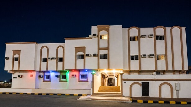 A multi-story building with a central entrance and multiple windows. - OrbitNet HJ (Madinah)