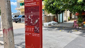 A directional signpost with multiple destination labels and distances.