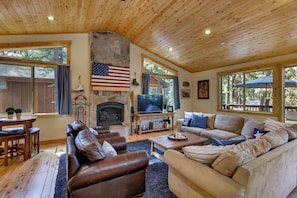 A cozy living room with a stone fireplace, leather sofas, and a television. - Powder Days & Lake Rays! Tahoe Vista Treasure (Kings Beach)