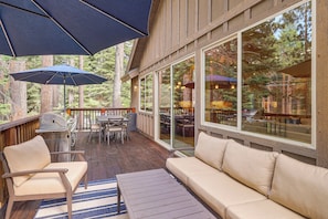 An outdoor deck with a sofa, chairs, a grill, and umbrellas. - Powder Days & Lake Rays! Tahoe Vista Treasure (Kings Beach)
